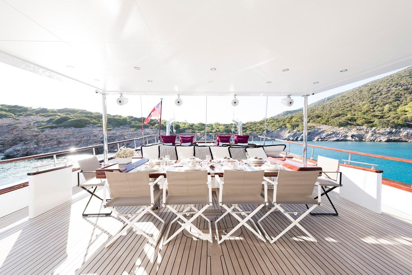 a deck with chairs and tables on it aboard THAT'S AMORE Yacht for Sale