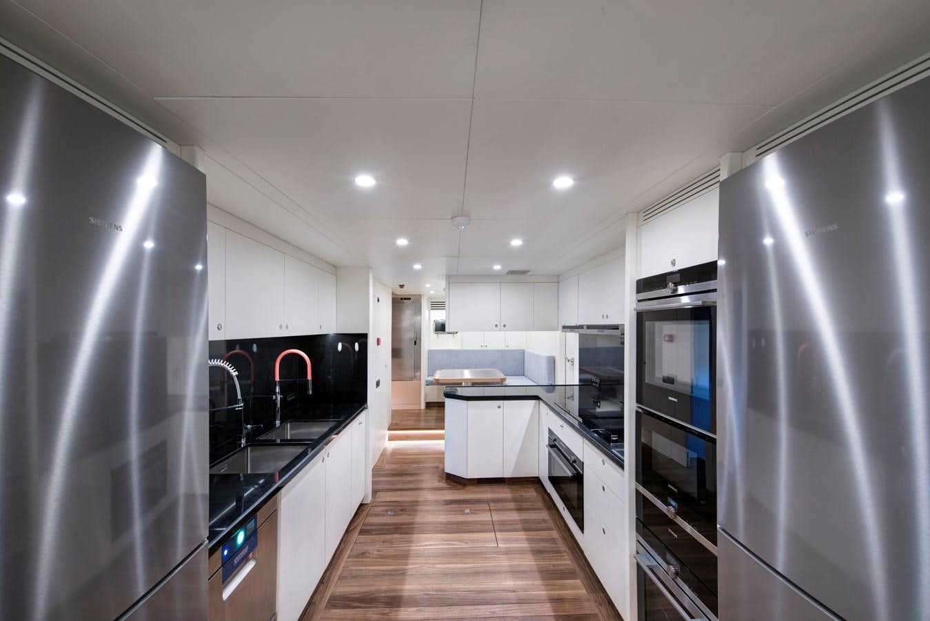 a kitchen with a wood floor aboard THAT'S AMORE Yacht for Sale