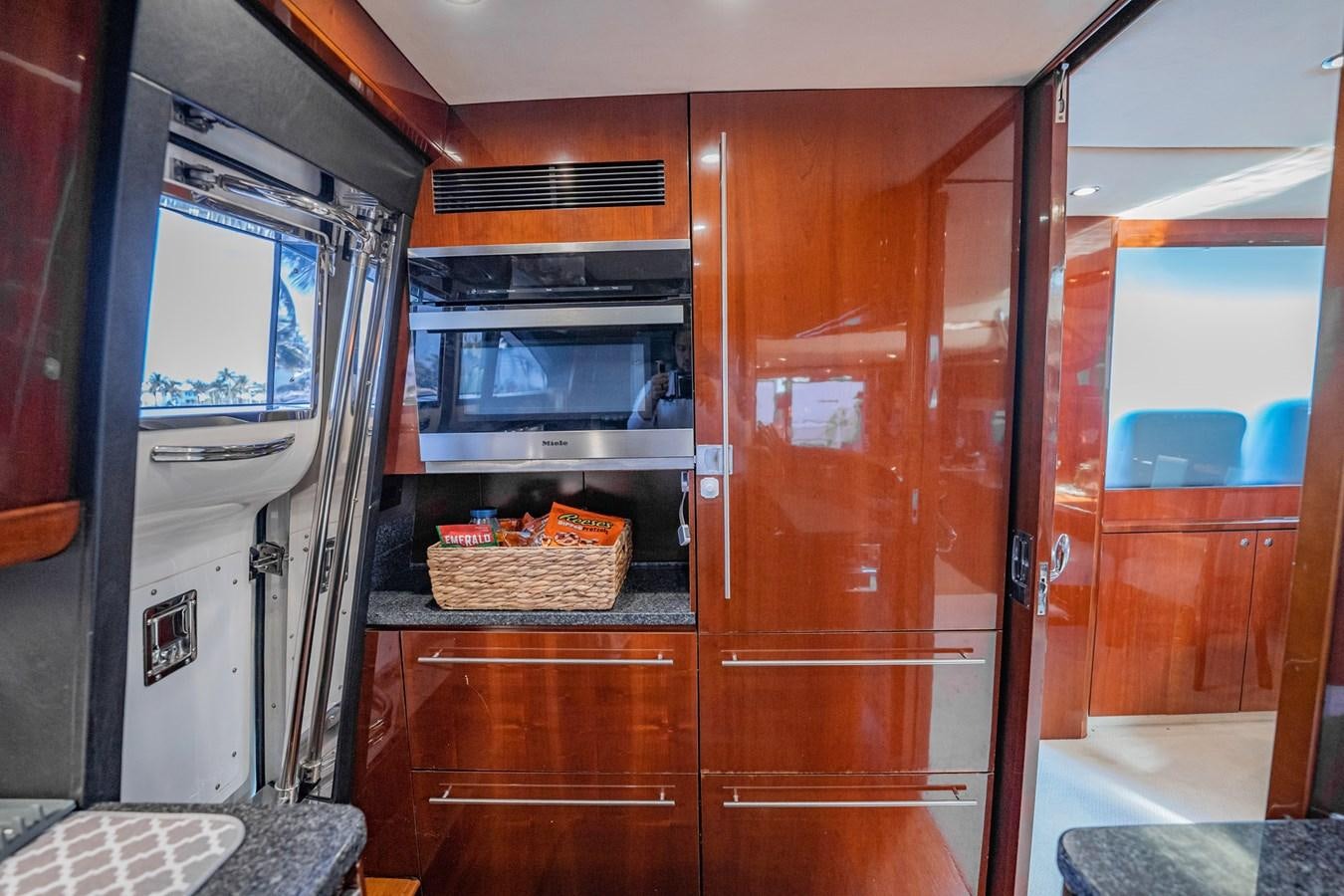 a kitchen with wooden cabinets aboard HALF MINE Yacht for Sale