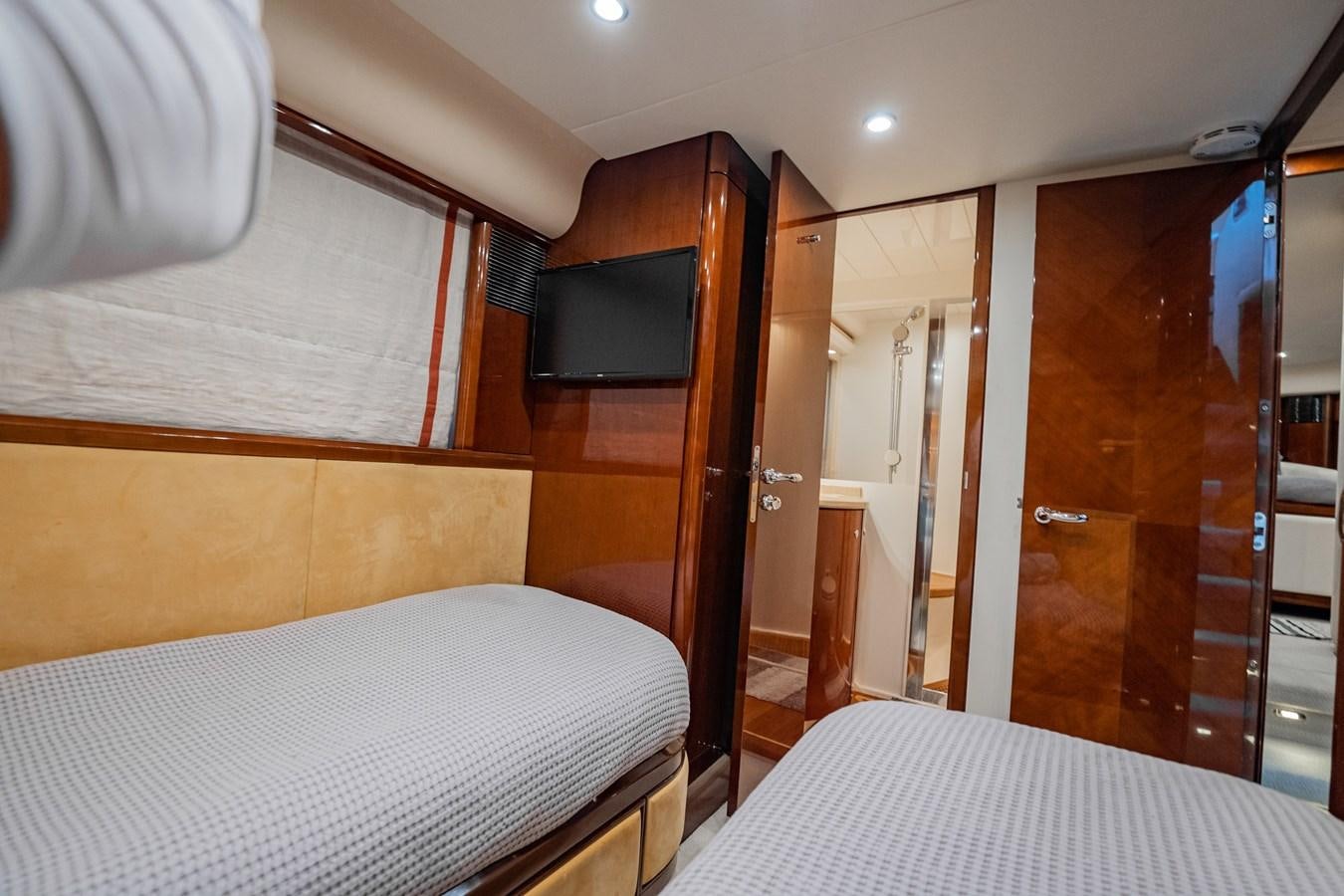 a room with a bed and a television aboard HALF MINE Yacht for Sale