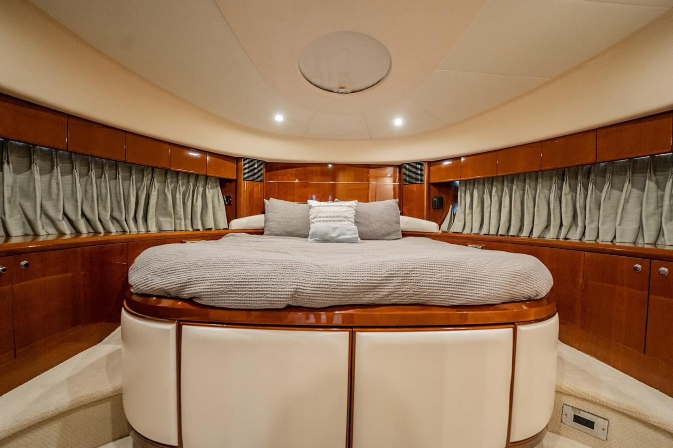 a bed with a white cover aboard HALF MINE Yacht for Sale
