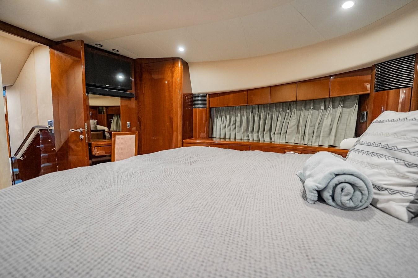 a bed with white sheets aboard HALF MINE Yacht for Sale