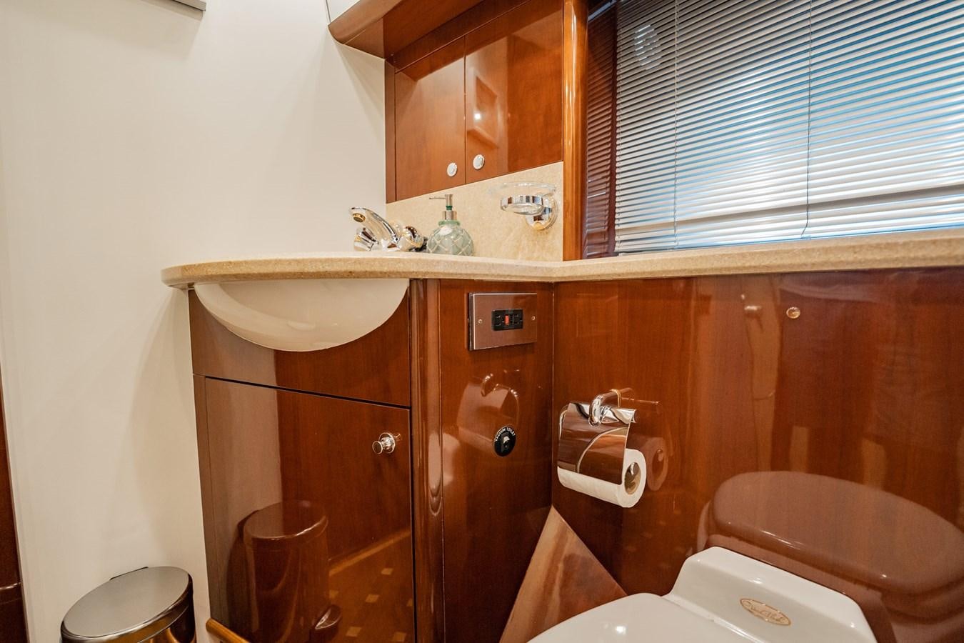 a bathroom with a sink toilet and a cabinet aboard HALF MINE Yacht for Sale
