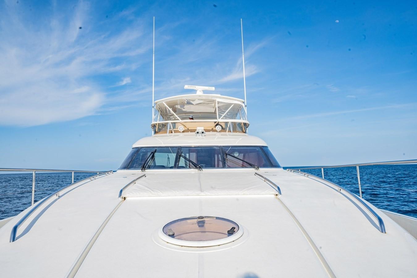 a white boat on a body of water aboard HALF MINE Yacht for Sale
