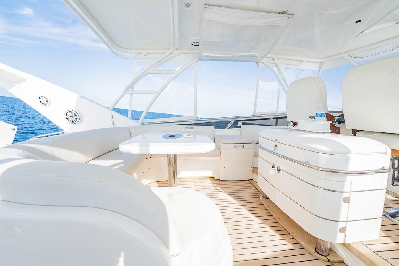 a white yacht with a white seat aboard HALF MINE Yacht for Sale