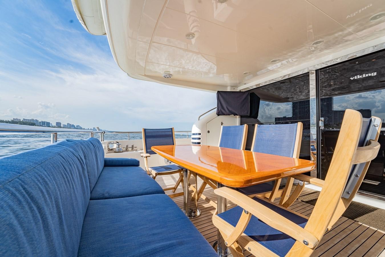 a boat with a table and chairs aboard HALF MINE Yacht for Sale
