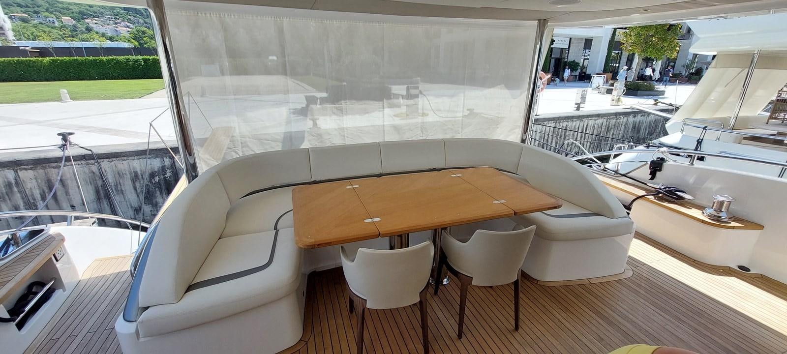 a room with a table chairs and a window aboard PERLA Yacht for Sale