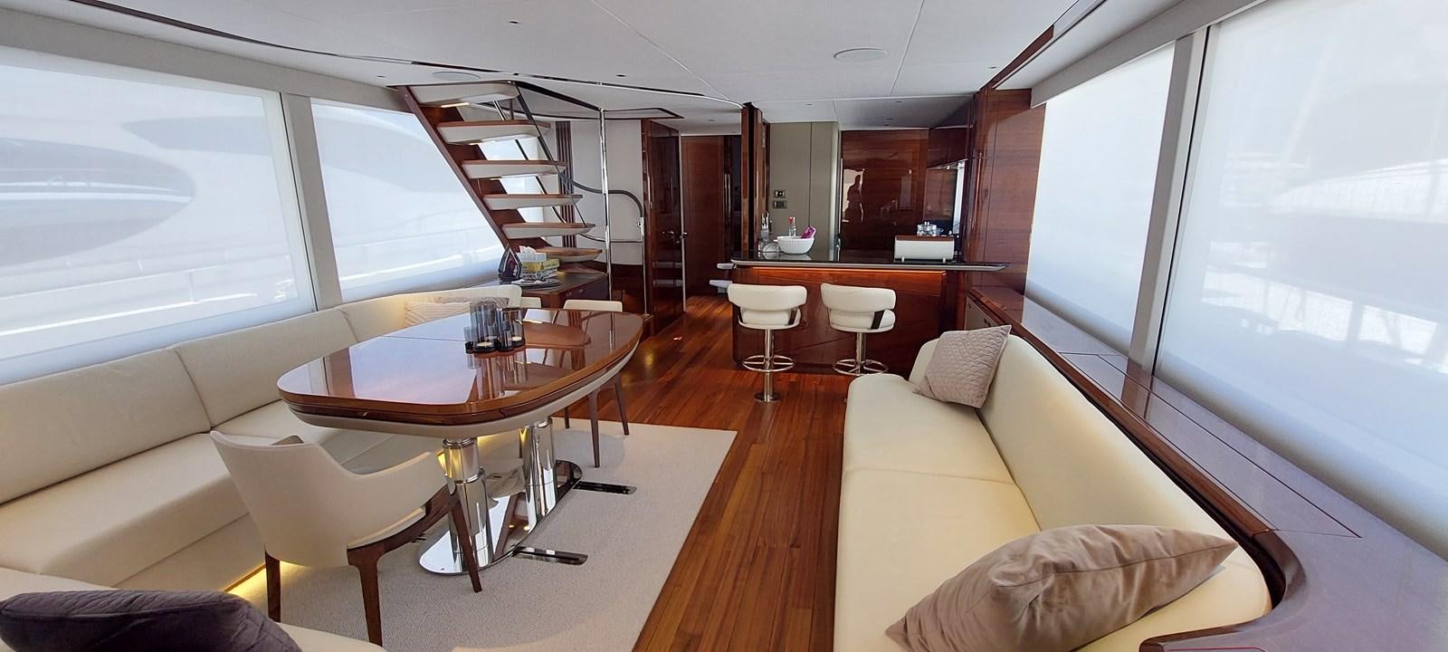 a living room with a table and chairs aboard PERLA Yacht for Sale