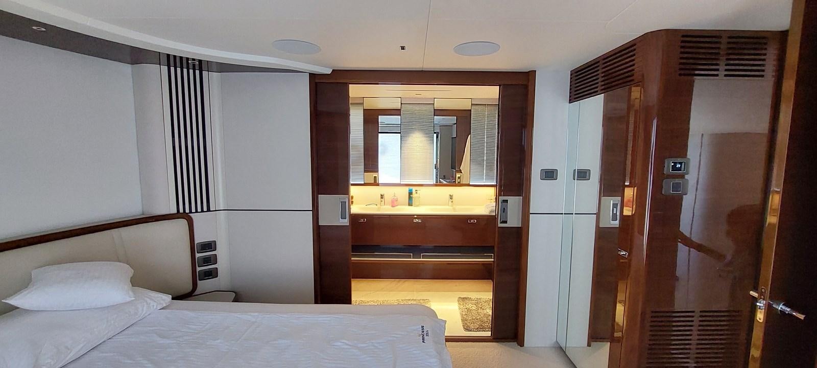 a room with a bed and a closet aboard PERLA Yacht for Sale