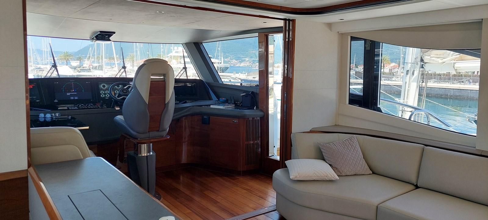 a room with a couch and a table and a window aboard PERLA Yacht for Sale