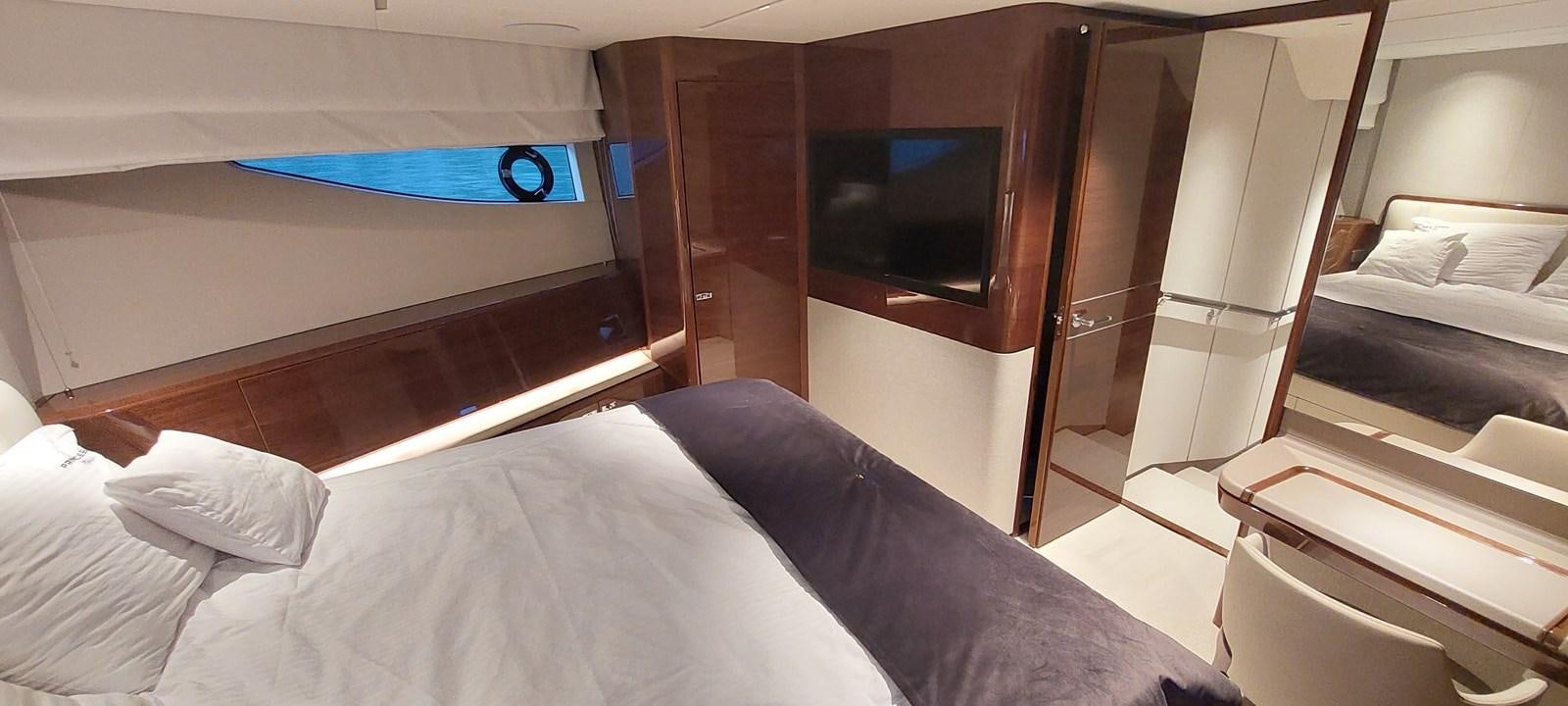 a room with a bed and a television aboard PERLA Yacht for Sale