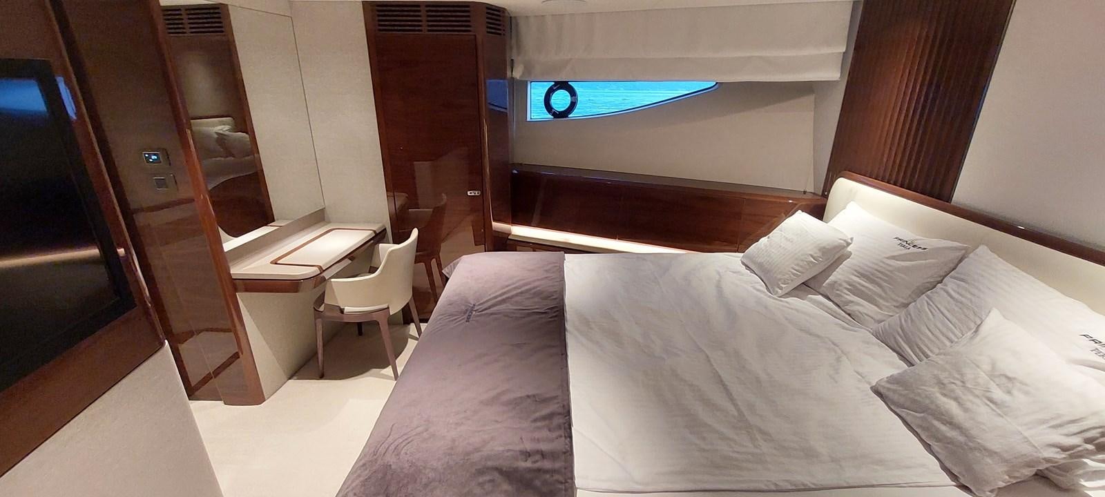 a bed with a desk and a computer on it aboard PERLA Yacht for Sale