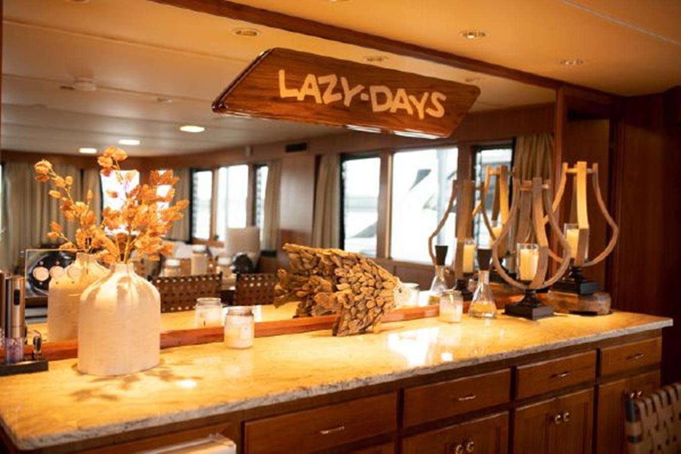 a kitchen with a chandelier and a vase with flowers aboard 88 LAZY DAYS BEACHEM Yacht for Sale