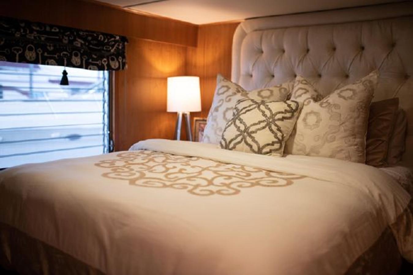 a bed with a lamp on it aboard 88 LAZY DAYS BEACHEM Yacht for Sale