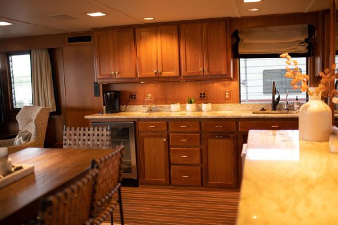 a kitchen with wooden cabinets aboard 88 LAZY DAYS BEACHEM Yacht for Sale