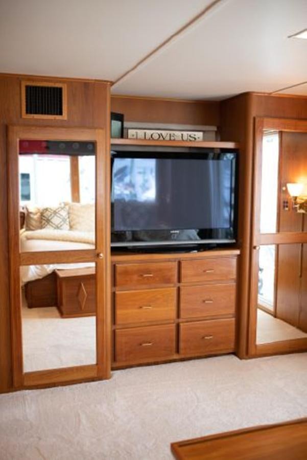 a room with a tv and dresser aboard 88 LAZY DAYS BEACHEM Yacht for Sale