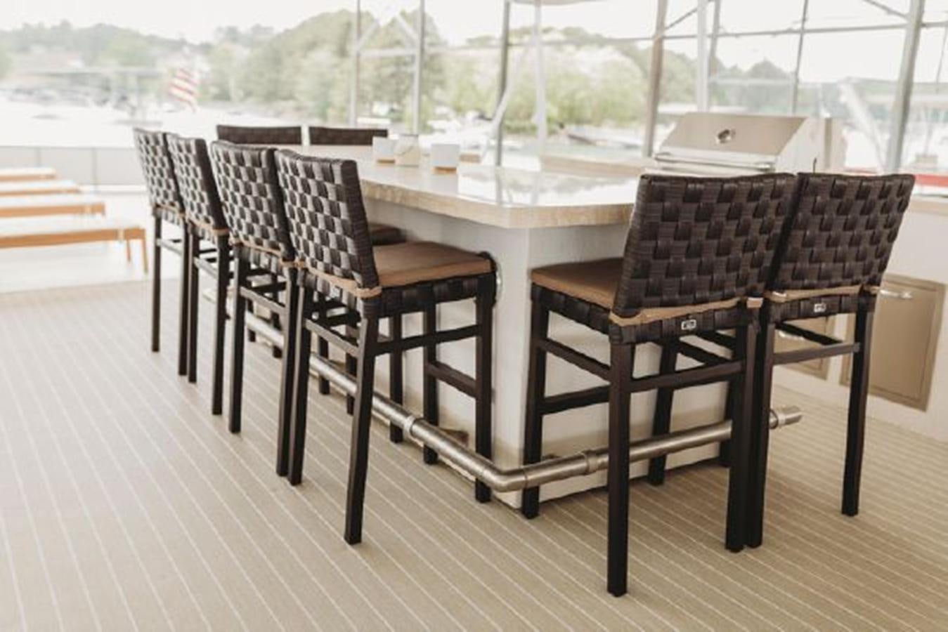 a table and chairs on a patio aboard 88 LAZY DAYS BEACHEM Yacht for Sale