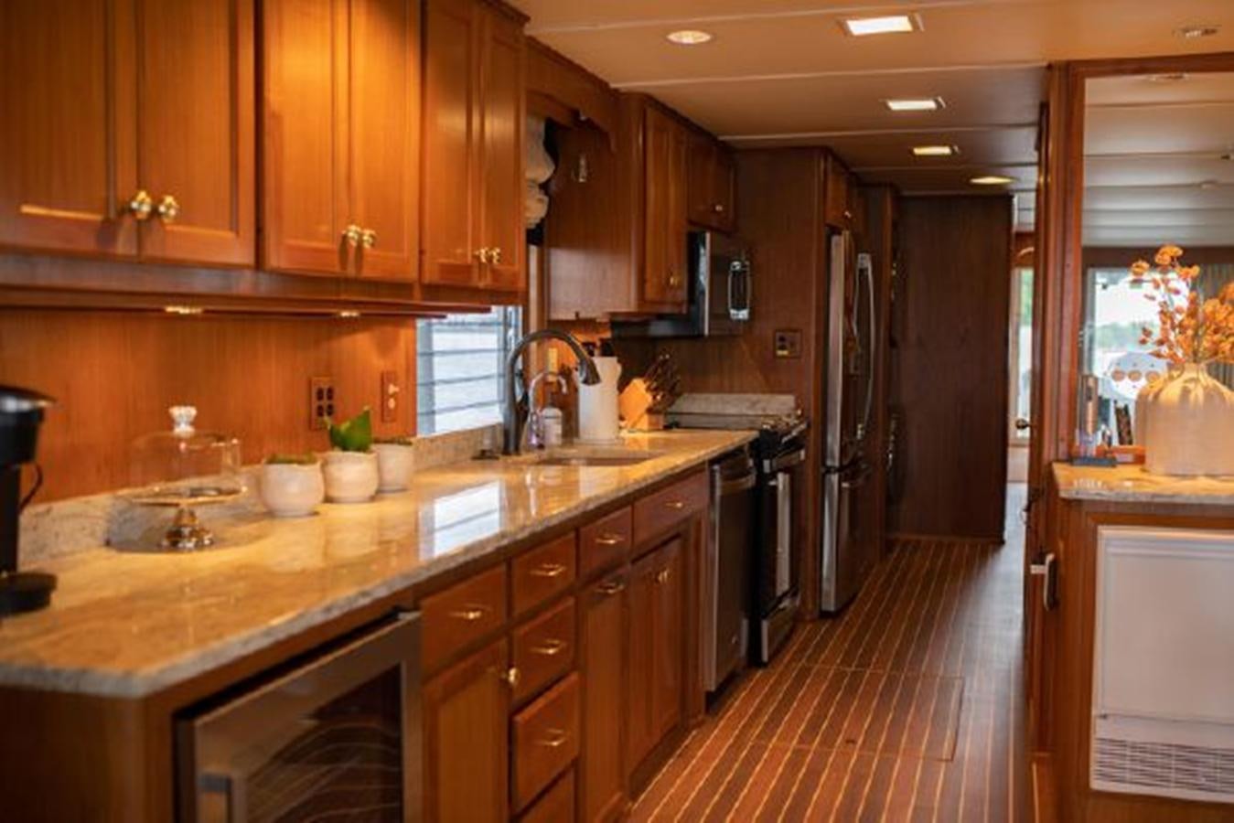 a kitchen with wooden cabinets aboard 88 LAZY DAYS BEACHEM Yacht for Sale