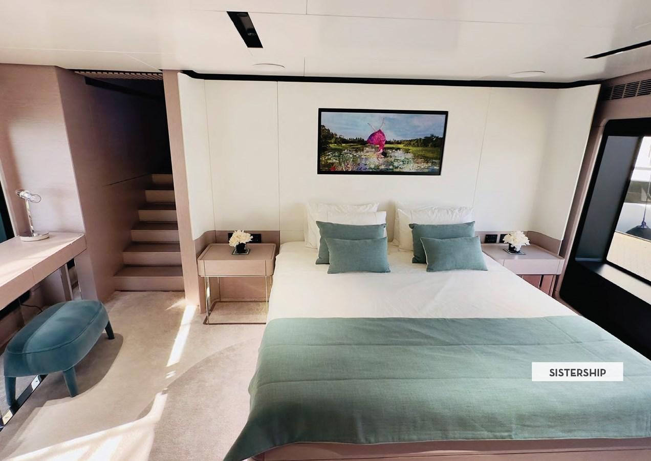 a bed with a blue sheet aboard 112DS MAZU Yacht for Sale
