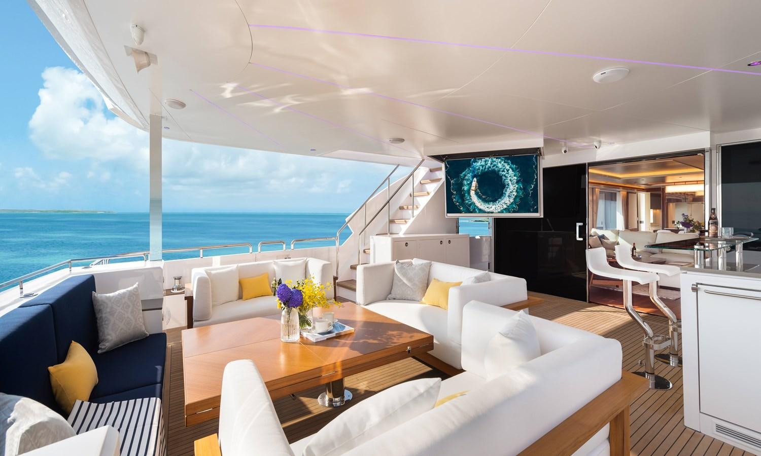a living room with a large television aboard HORIZON FD110 Yacht for Sale