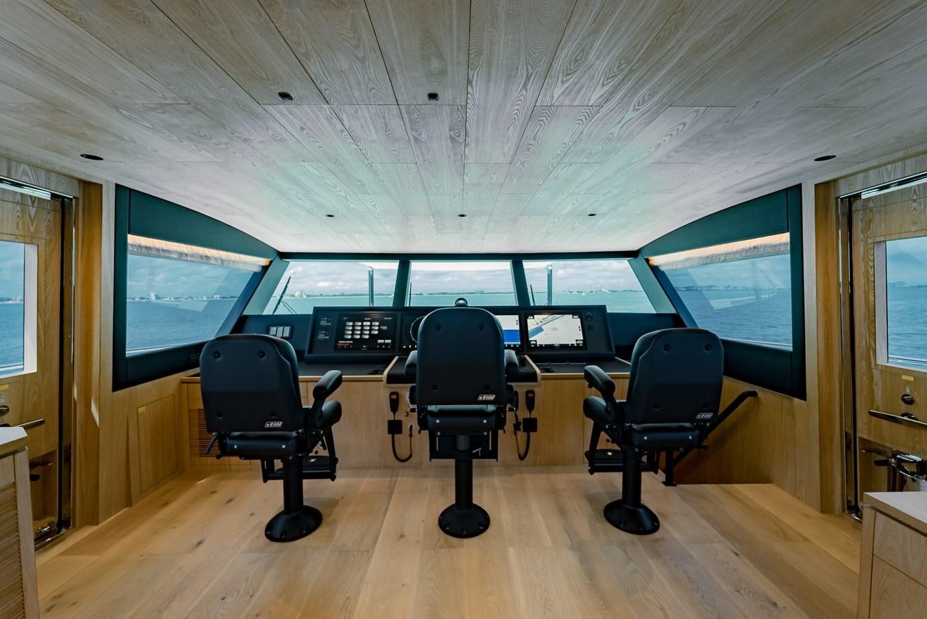 a room with chairs and a table aboard HORIZON FD110 Yacht for Sale