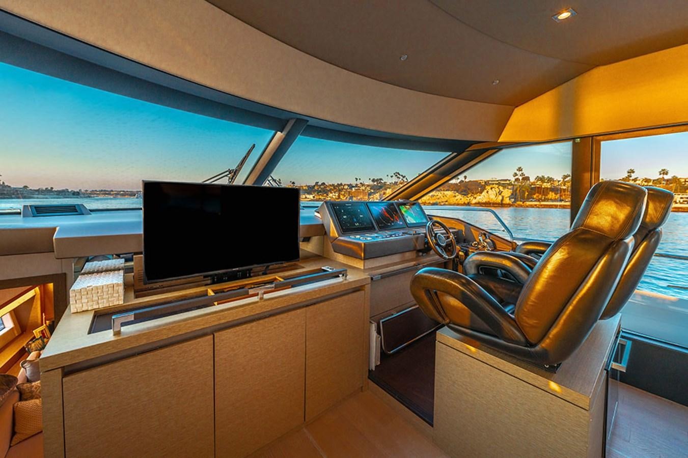 a room with a tv and a couch aboard 2018 PRESTIGE 680 Yacht for Sale