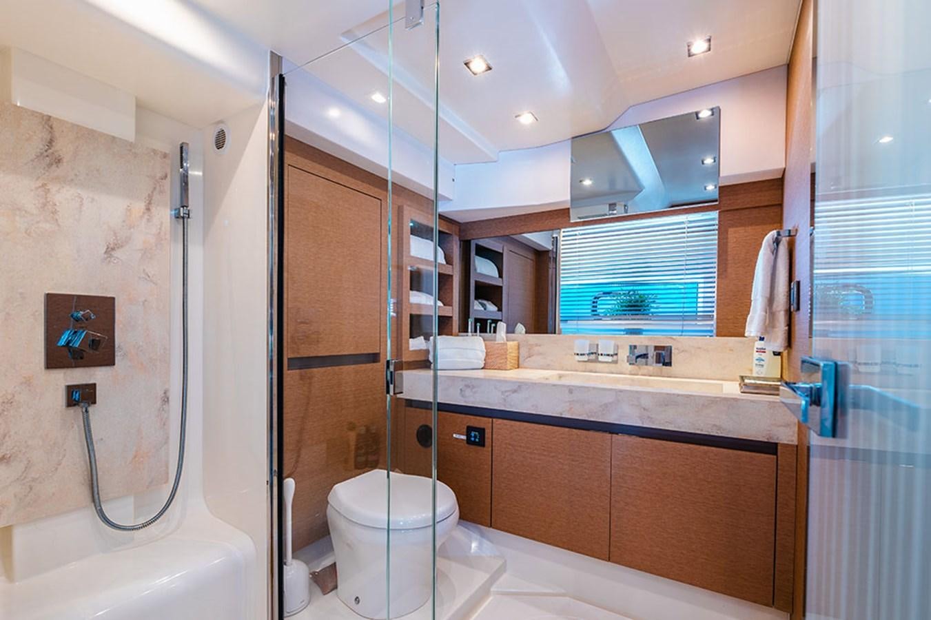 a bathroom with a shower unit and a toilet aboard 2018 PRESTIGE 680 Yacht for Sale