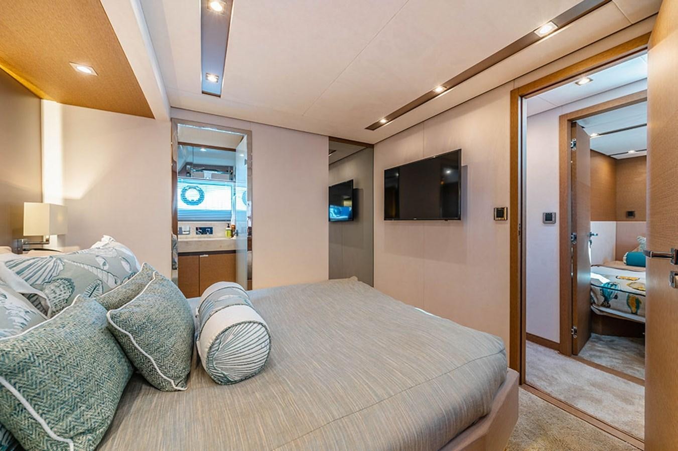 a bedroom with a bed and a television aboard 2018 PRESTIGE 680 Yacht for Sale
