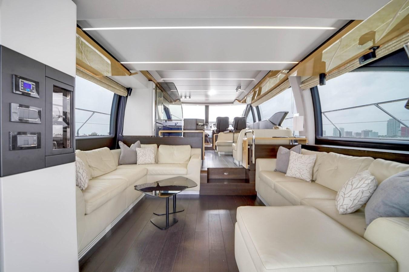 a living room with a couch and a table aboard 2017 66' AZIMUT Yacht for Sale