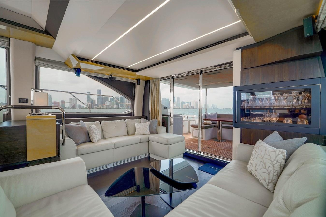 a living room with a large window aboard 2017 66' AZIMUT Yacht for Sale