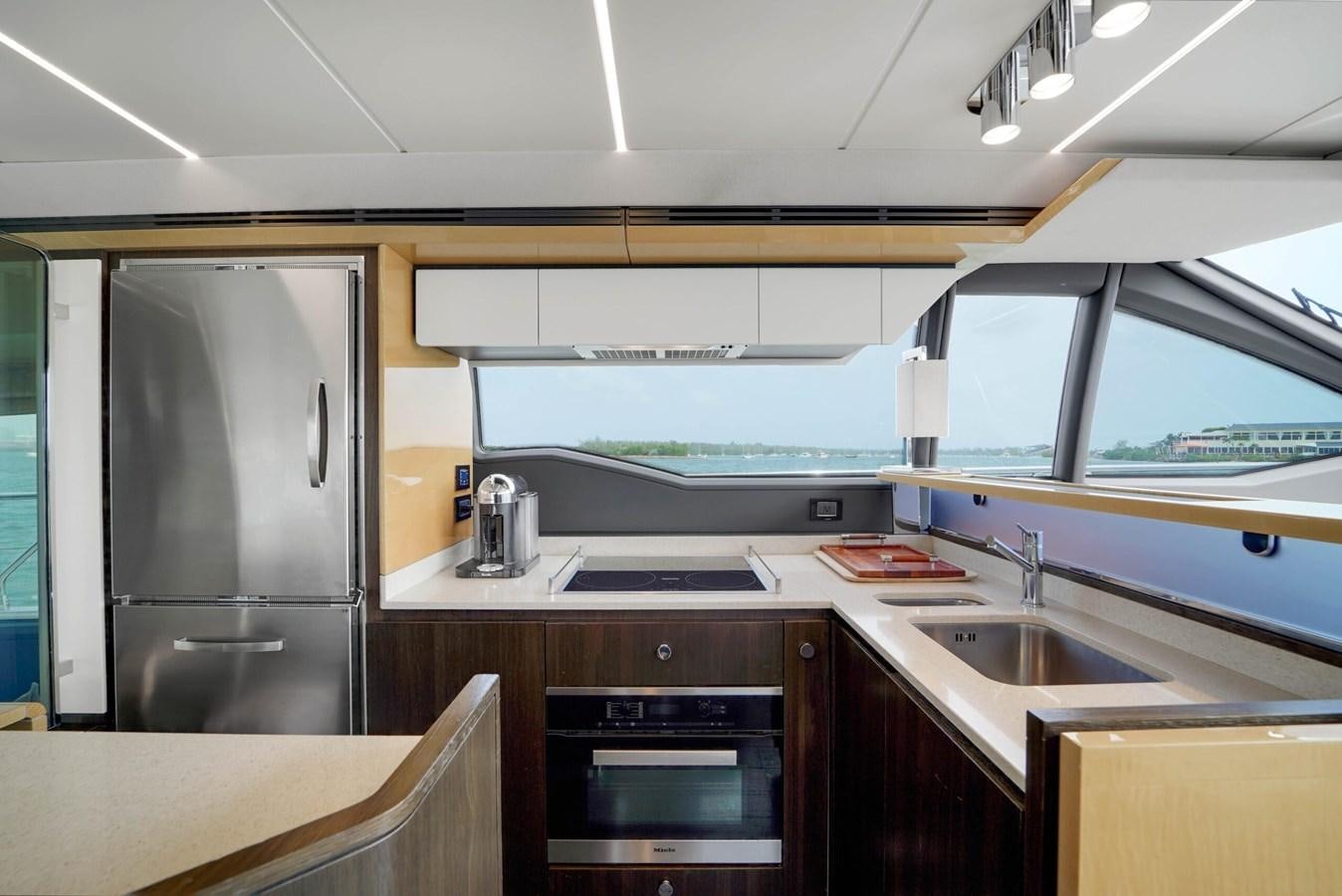 a kitchen with a sink and stove aboard 2017 66' AZIMUT Yacht for Sale