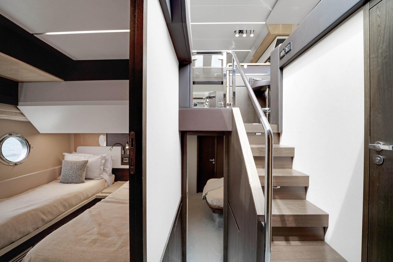 a room with a bed and a staircase aboard 2017 66' AZIMUT Yacht for Sale