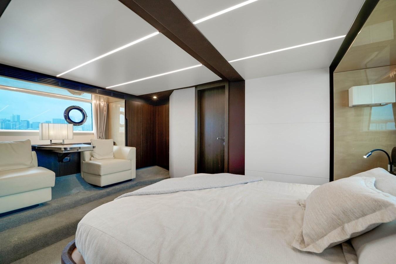 a room with a bed and a desk aboard 2017 66' AZIMUT Yacht for Sale