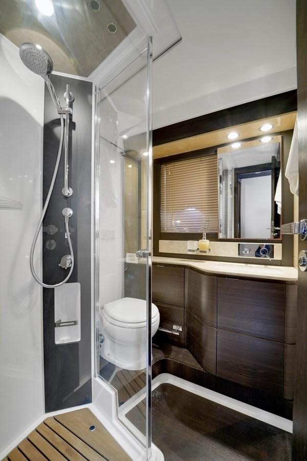 a bathroom with a shower unit and toilet aboard 2017 66' AZIMUT Yacht for Sale