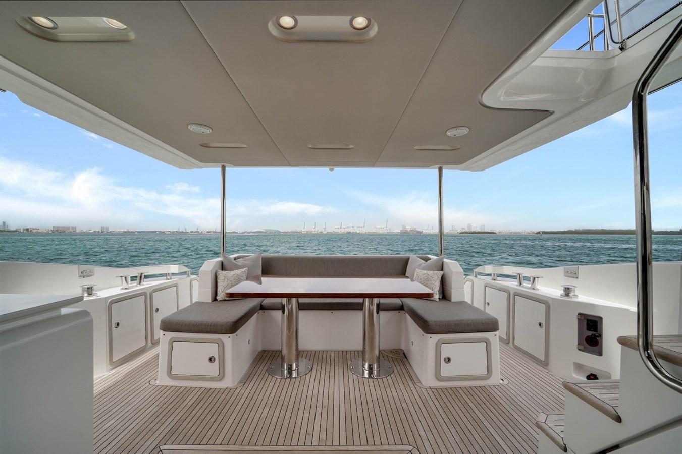 a room with a bed and a table aboard 2017 66' AZIMUT Yacht for Sale