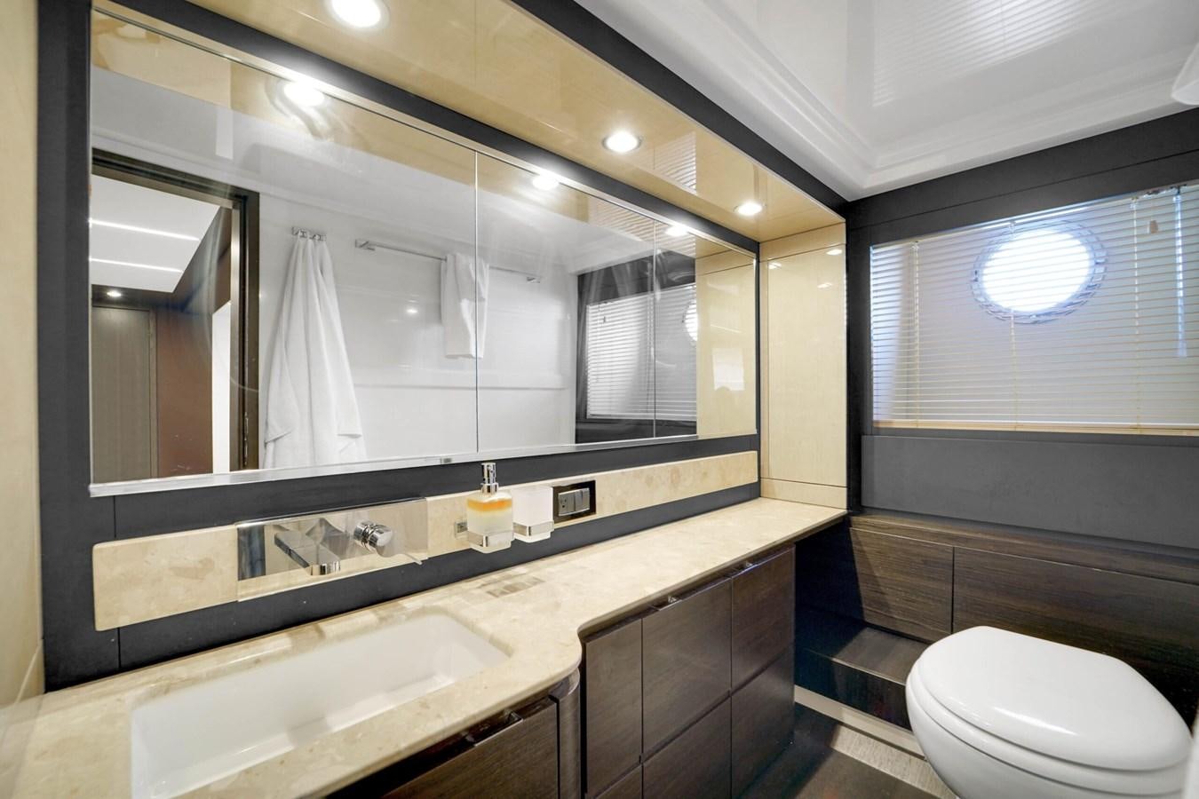 a bathroom with a large mirror aboard 2017 66' AZIMUT Yacht for Sale