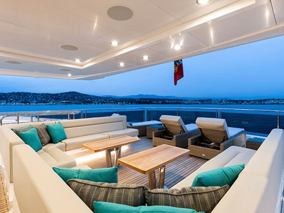 a room with couches and a table and chairs aboard ELYSIUM Yacht for Sale