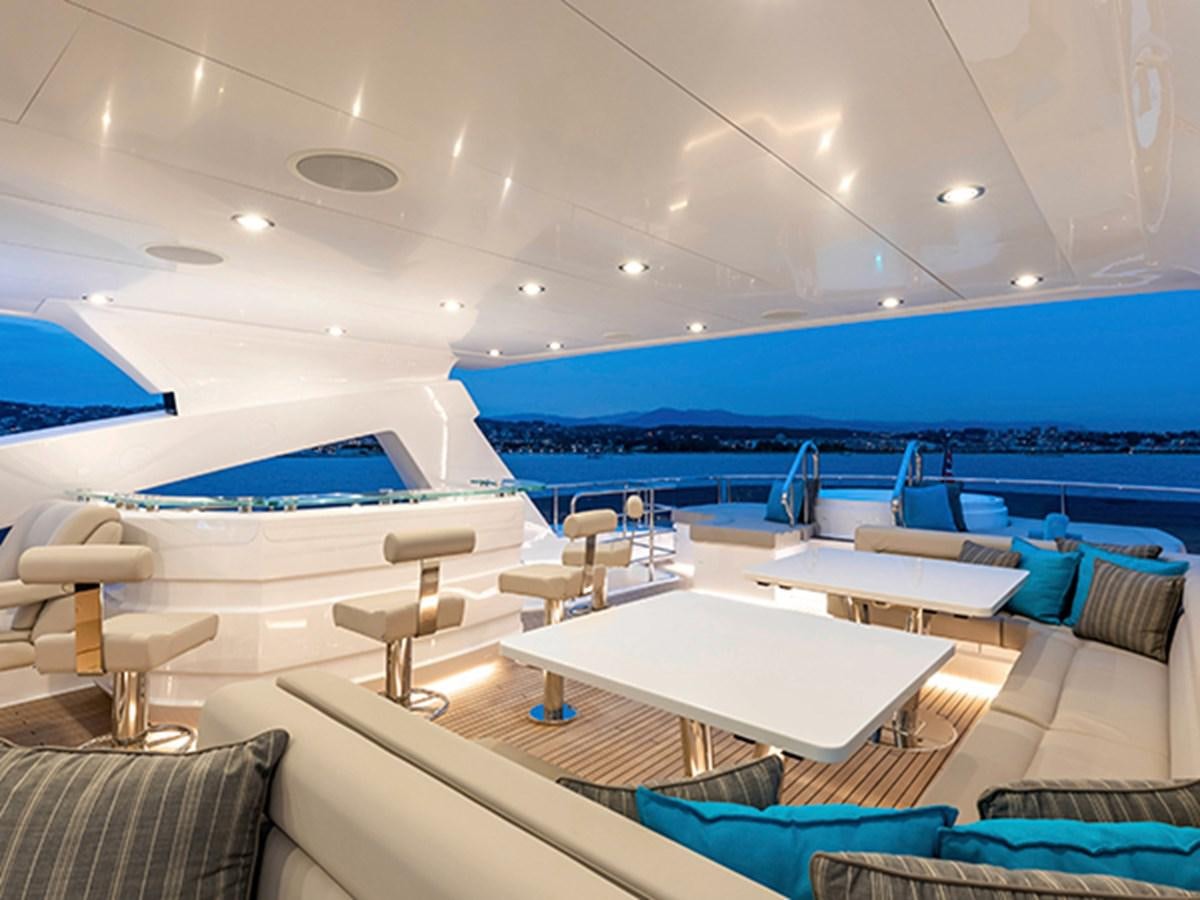 a room with a pool and lounge chairs aboard ELYSIUM Yacht for Sale