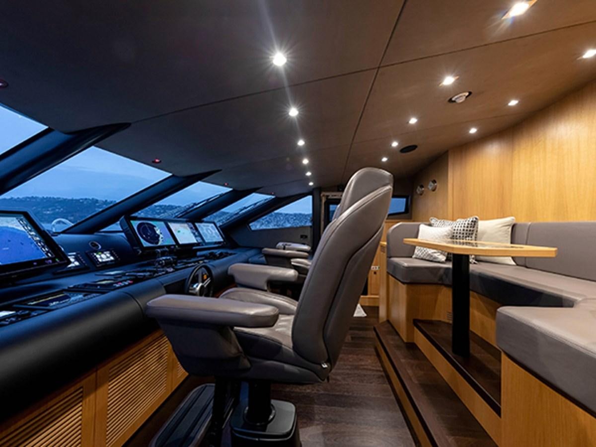 a room with a car and a desk with chairs aboard ELYSIUM Yacht for Sale
