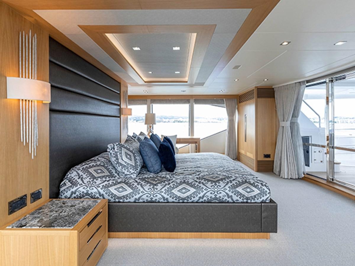 a bedroom with a large bed aboard ELYSIUM Yacht for Sale