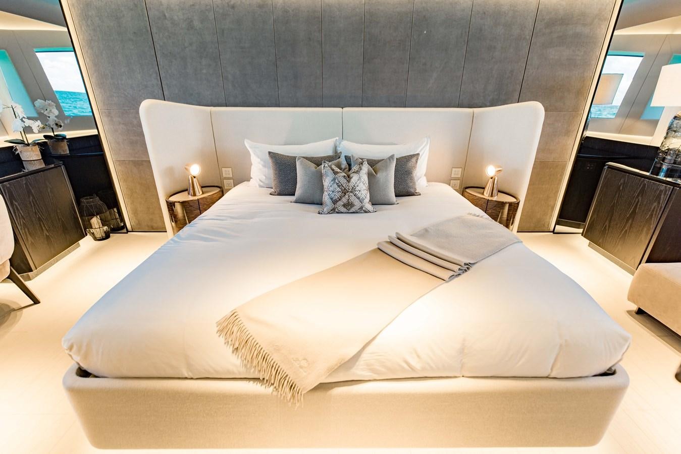 a large bed with white sheets aboard OFFLINE Yacht for Sale
