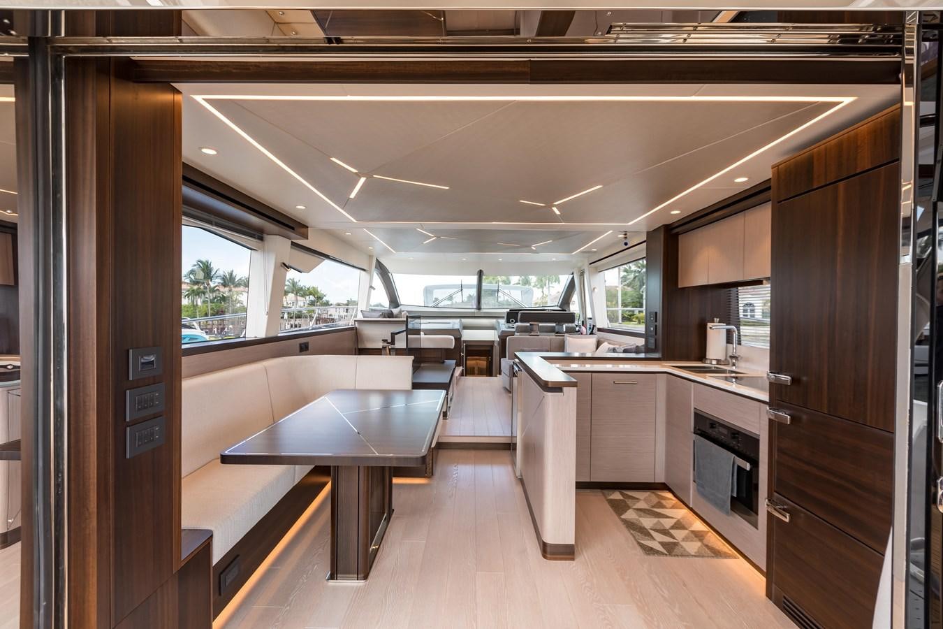a large kitchen with a table aboard NAVAL Yacht for Sale