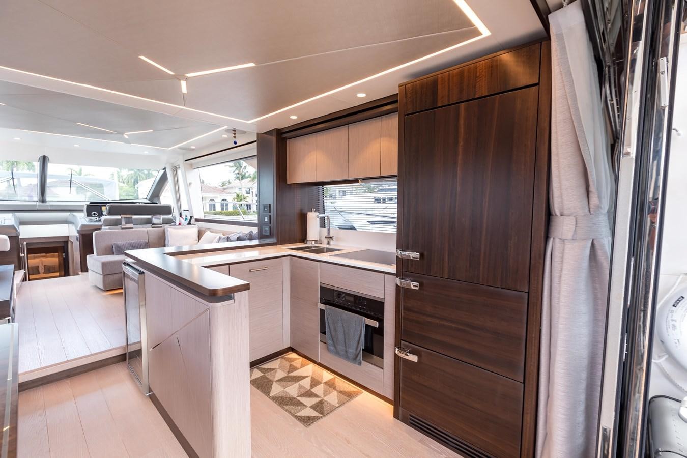 a kitchen with a large window aboard NAVAL Yacht for Sale