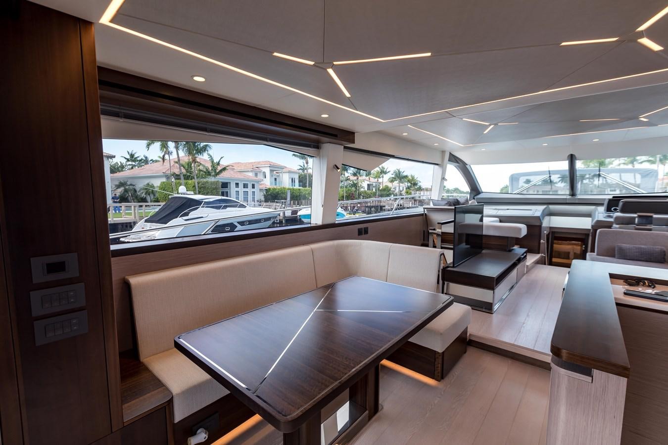 a room with tables and chairs aboard NAVAL Yacht for Sale