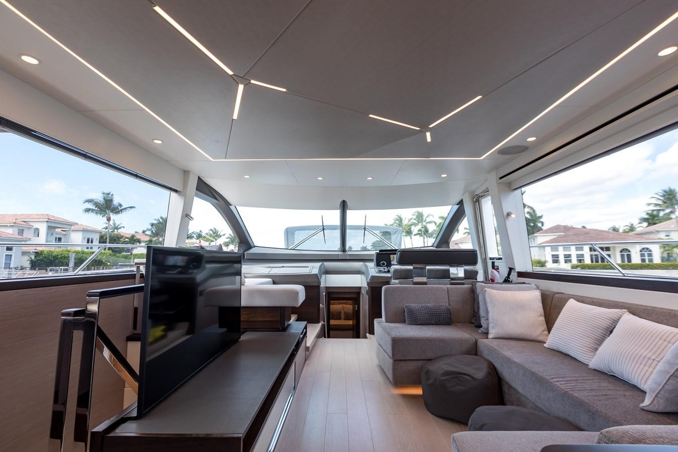 a room with a couch and a piano aboard NAVAL Yacht for Sale