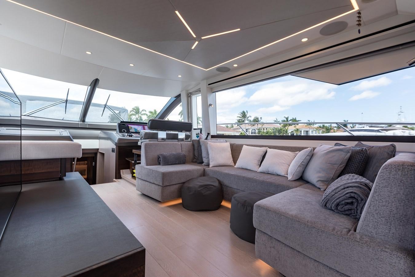 a room with a couch and a table aboard NAVAL Yacht for Sale