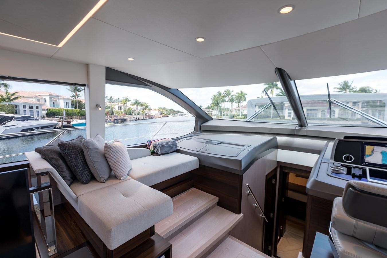 a room with a large window and a view of the water aboard NAVAL Yacht for Sale