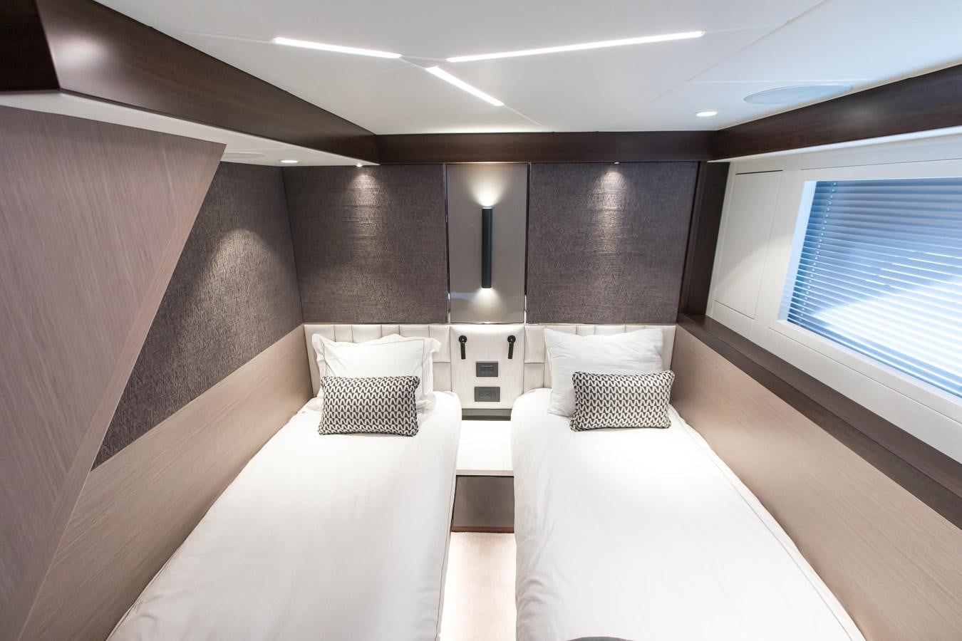 a room with a couple of beds aboard NAVAL Yacht for Sale