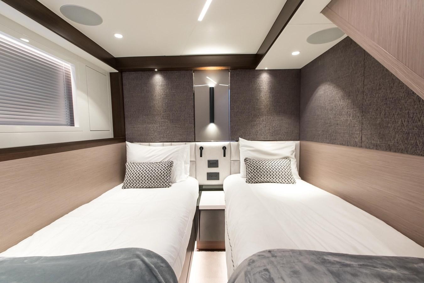 a room with two beds aboard NAVAL Yacht for Sale