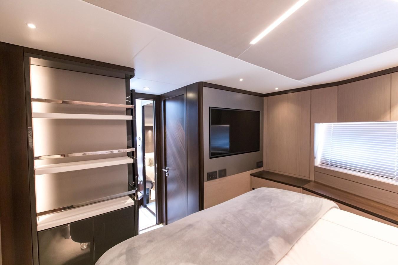 a room with a bed and a tv aboard NAVAL Yacht for Sale